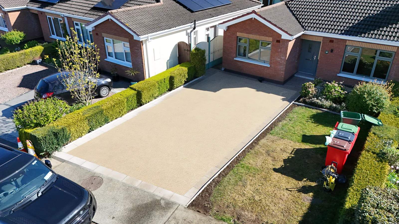 Finished resin-bound driveway with a clean sand-coloured finish